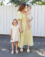 Load image into Gallery viewer, Rylee+Cru Marina Dress in ivory, flowing sleeveless dress with a relaxed fit, styled outdoors with greenery in the background.