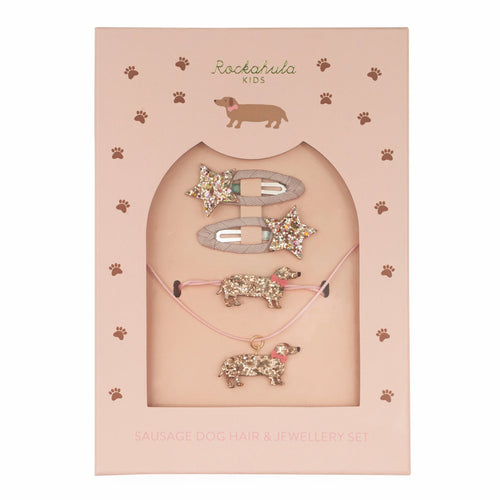 Set of sausage dog-themed jewelry including a necklace, bracelet, and hair clip in packaging with 'Rockahula Kids' branding.