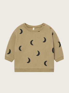 Beige sweatshirt with black moon patterns on a beige background