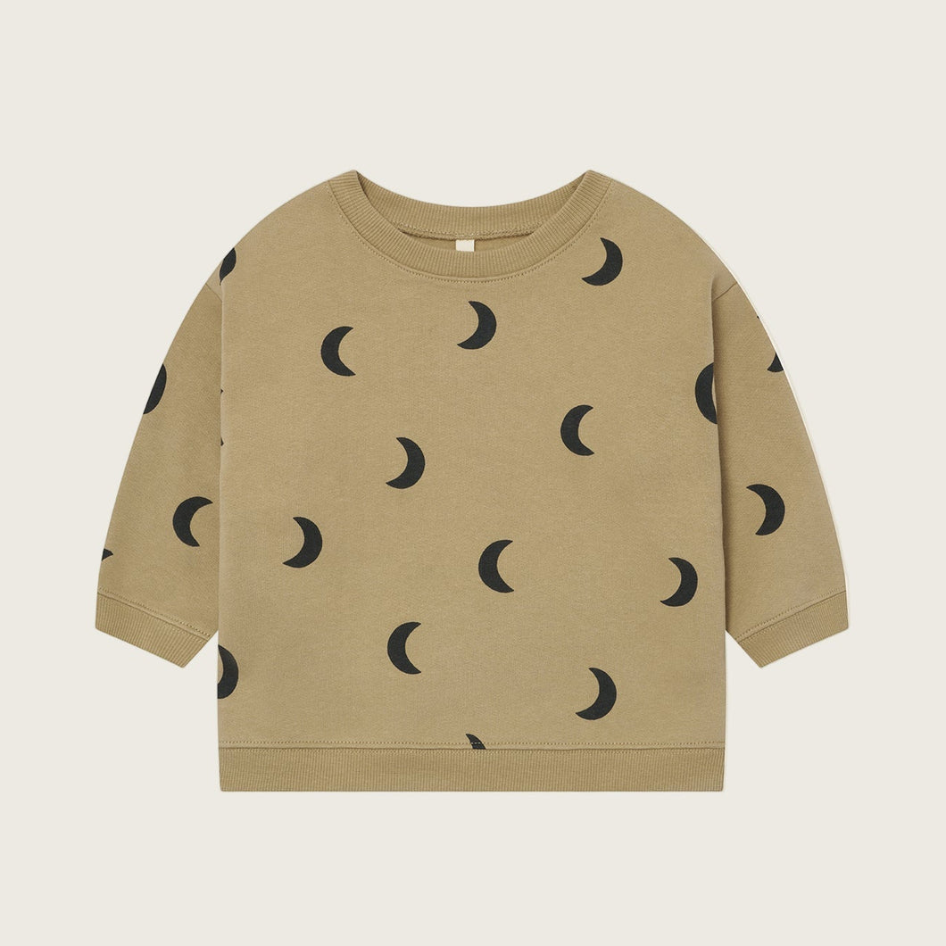 Beige sweatshirt with black moon pattern on a beige background