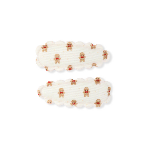 Pair of white earrings with gold accents on a white background