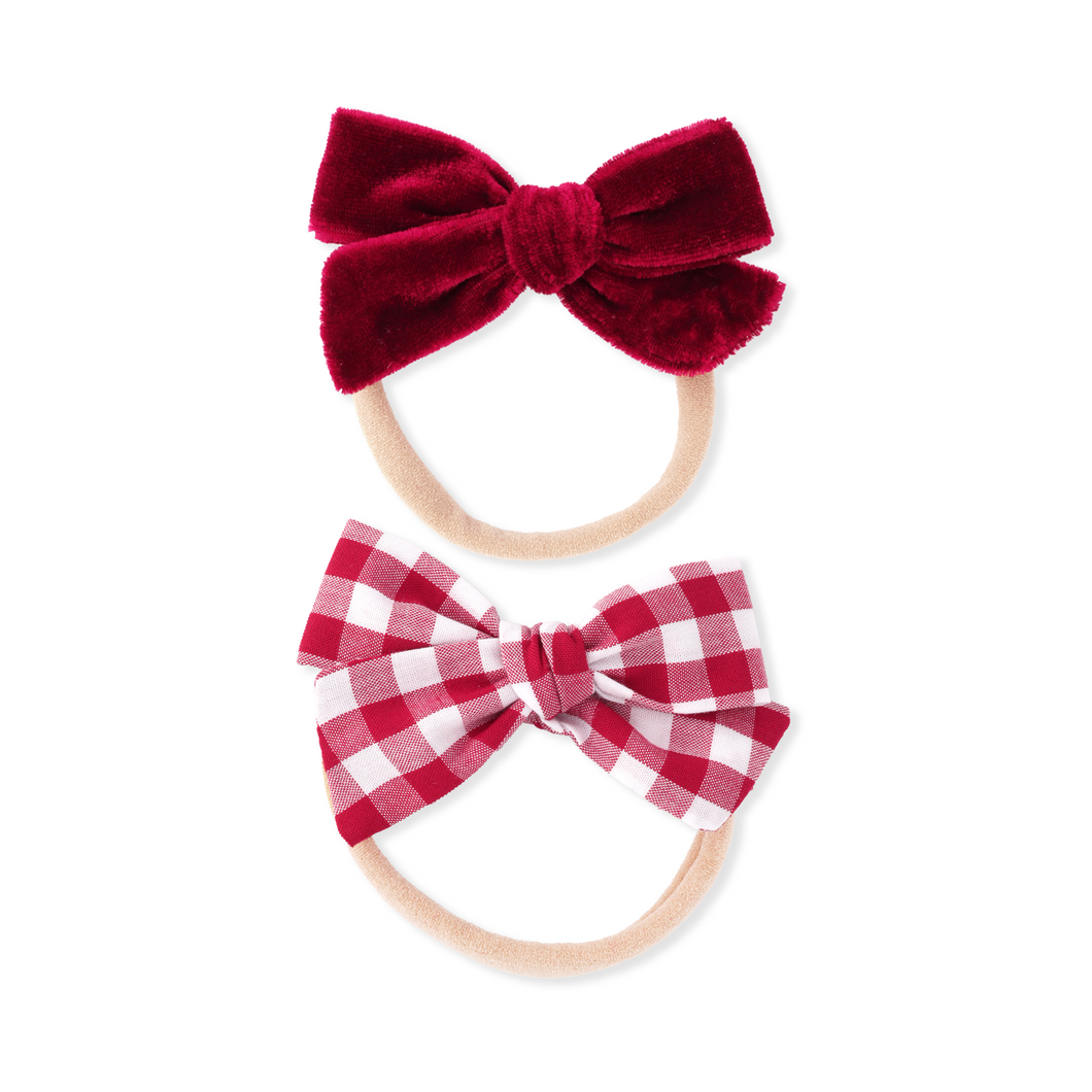 Two red and white checkered hair bows on white background