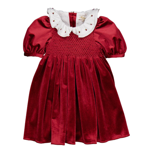 Red velvet dress with white ruffled collar on a white background