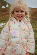 Load image into Gallery viewer, Young girl wearing a floral quilted jacket in a natural setting