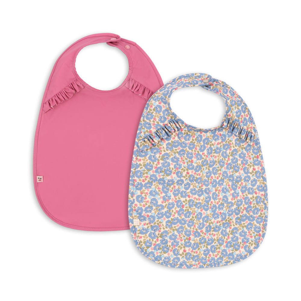 Two baby bibs, one pink and one with a floral pattern, on a white background.