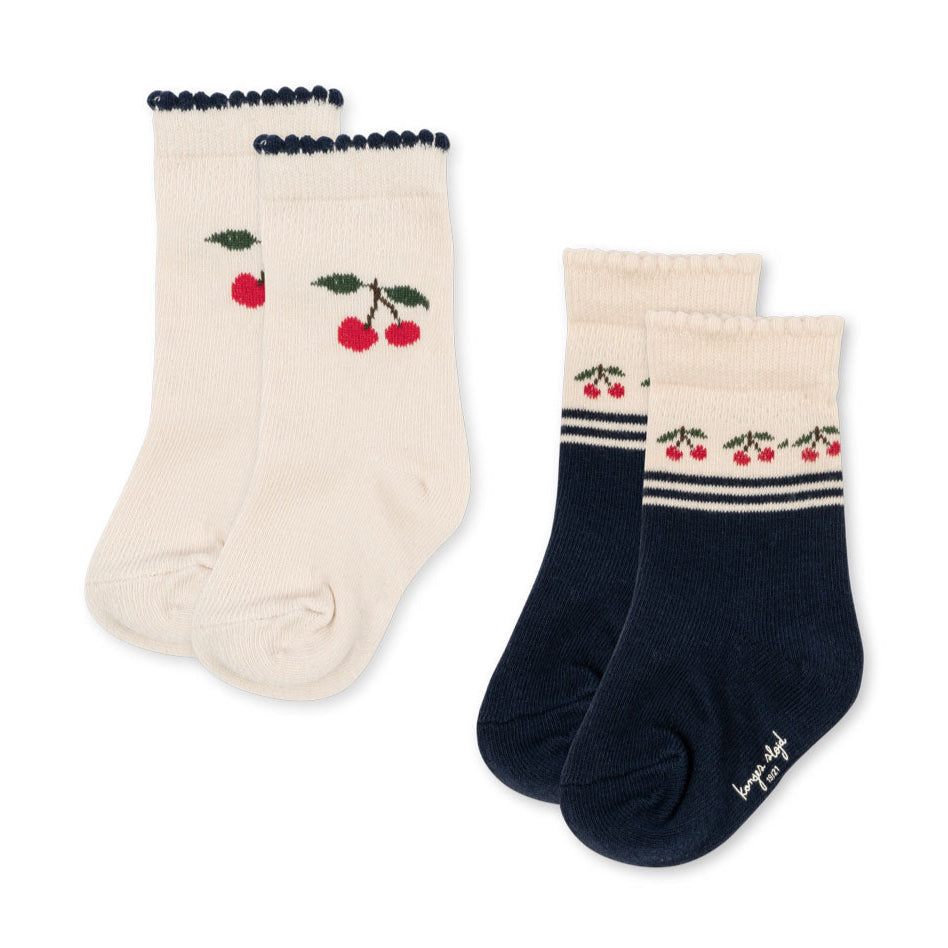 Two pairs of socks with cherry design on a white background