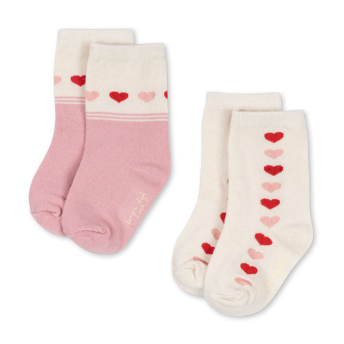 Pair of socks with heart patterns on a white background