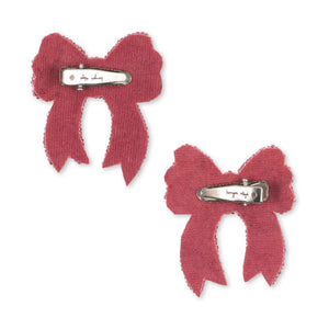 Two pink bow hair clips on a white background