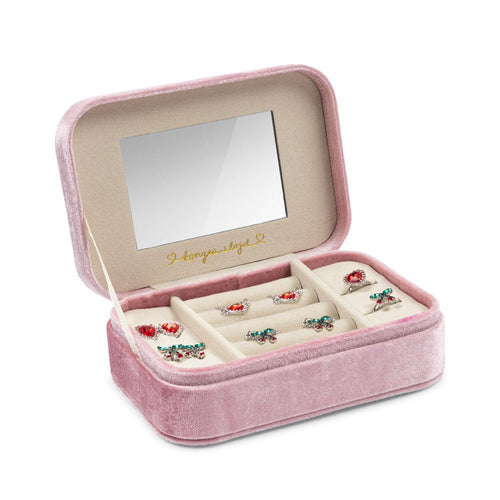 Pink jewelry box with mirror lid containing small jewelry items on a white background