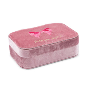 Pink velvet jewelry box with a bow design on a white background