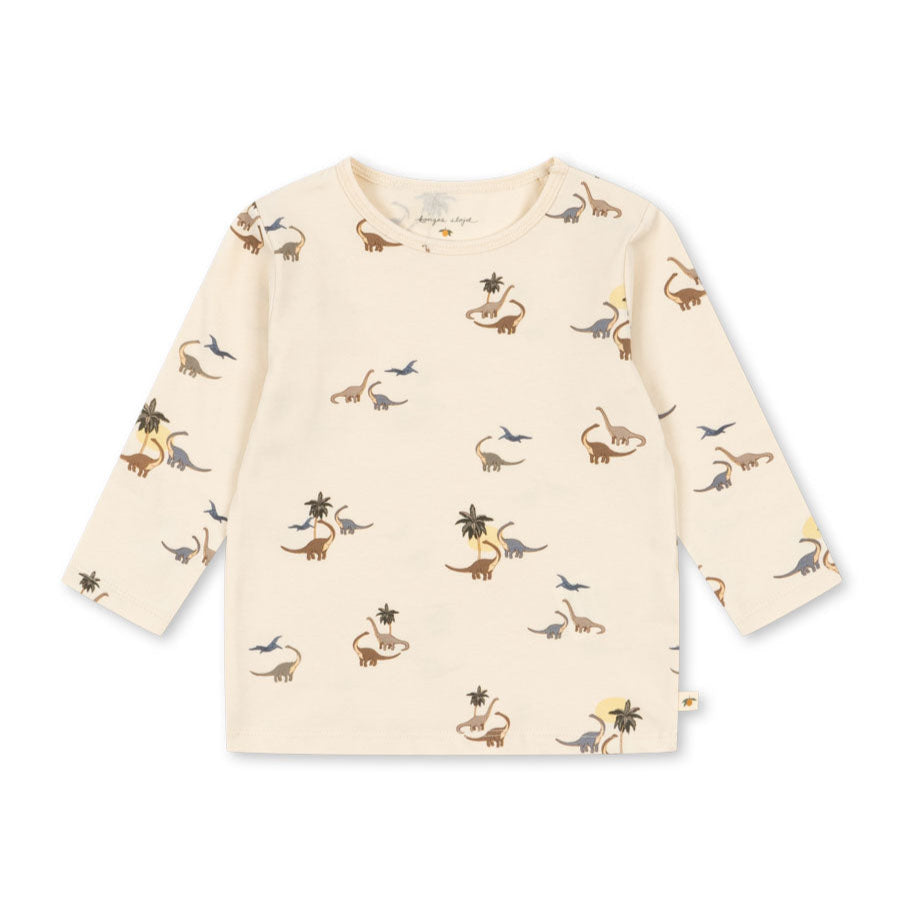 Beige long-sleeve shirt with dinosaur print on a white background