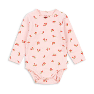 Pink baby bodysuit with floral pattern on a white background