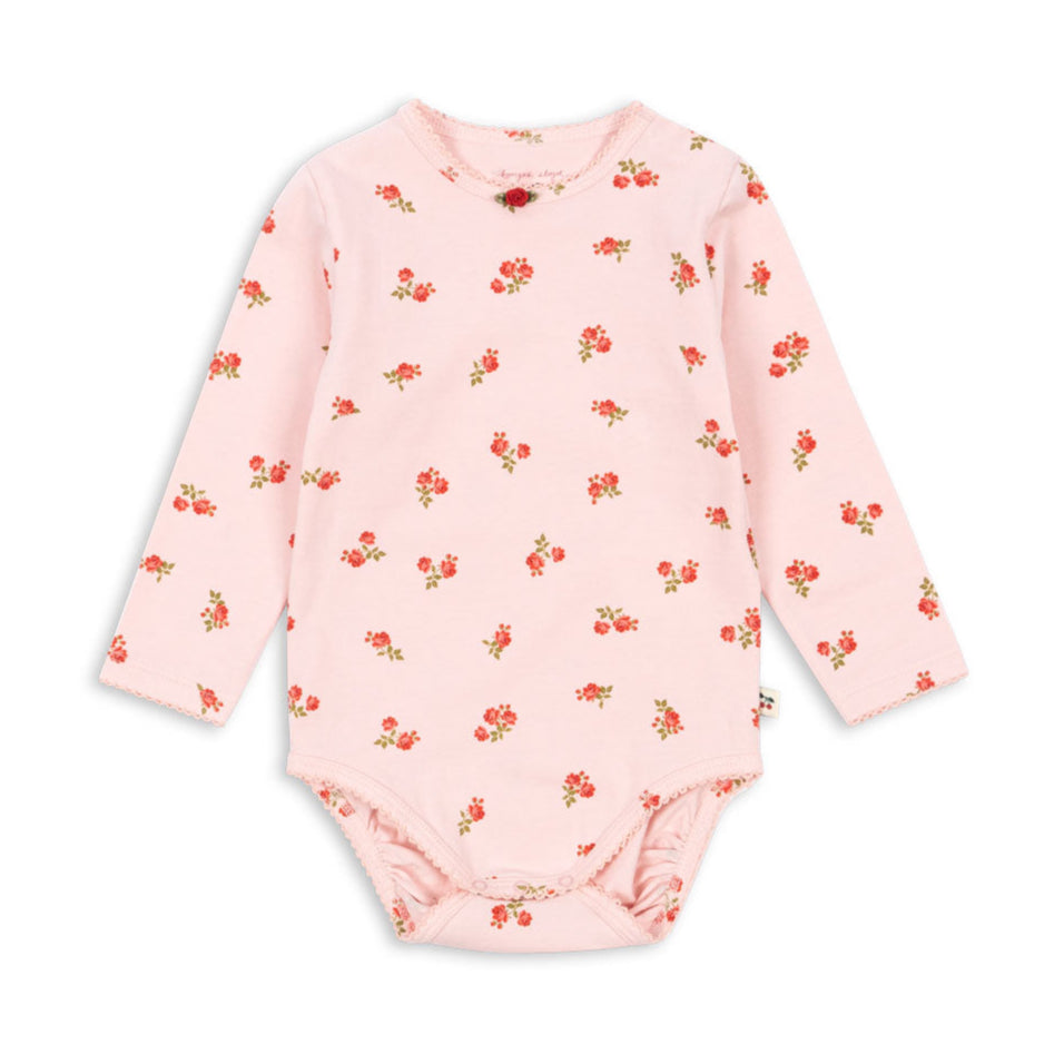 Pink baby bodysuit with floral pattern on a white background