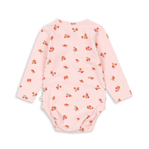 Pink baby bodysuit with red floral pattern on a white background