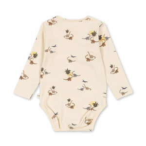 Baby bodysuit with dinosaur pattern on a white background