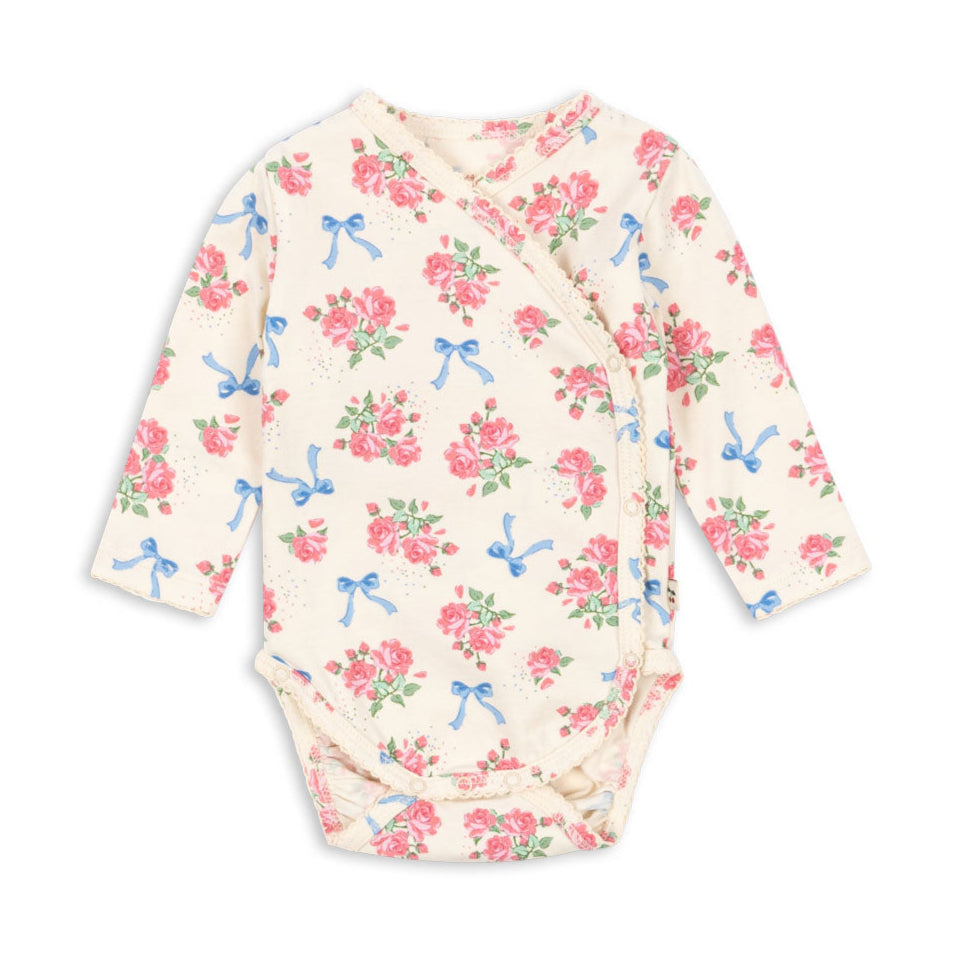 Floral-patterned baby bodysuit with bows on a white background
