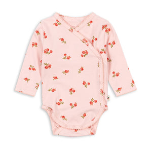 Pink baby bodysuit with floral pattern on a white background