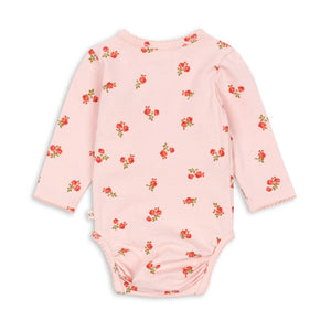 Pink baby onesie with floral pattern on a white background
