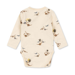 Baby onesie with dinosaur pattern on a white background