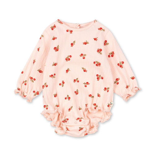Pink baby romper with red floral pattern on a white background