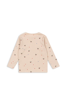 Beige cardigan with small patterns on a white background