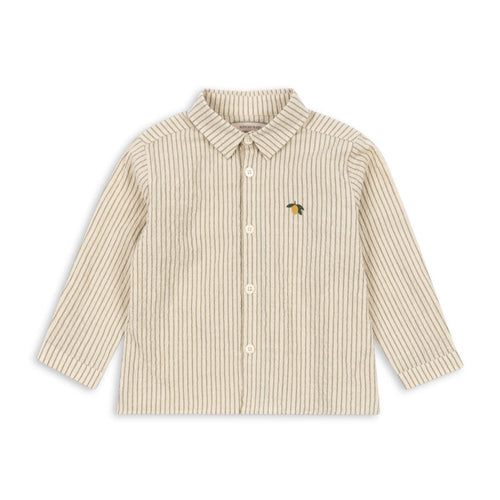 Beige and white striped shirt with a small embroidered design on a white background