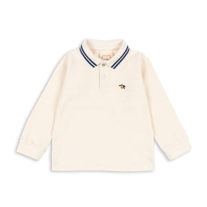 Cream-colored long-sleeve shirt with a small logo on a white background