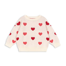 Load image into Gallery viewer, Cream-colored sweater with red heart patterns on a white background