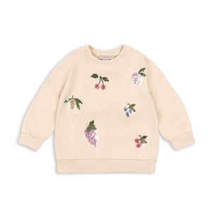 Beige sweatshirt with floral embroidery on a white background