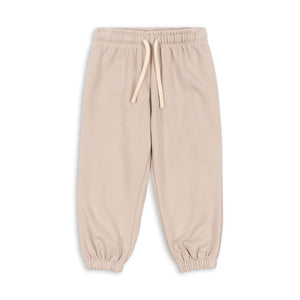 Beige sweatpants with a drawstring on a white background