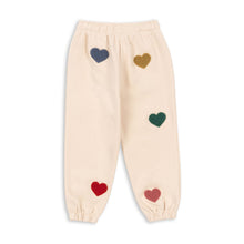 將圖片載入圖庫檢視器 Beige pants with colorful heart patterns on a white background