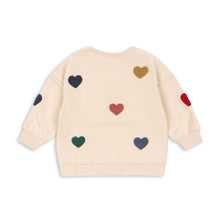 將圖片載入圖庫檢視器 Beige sweater with colorful heart patterns on a white background