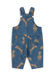 Blue denim overalls with gold patterns on a white background
