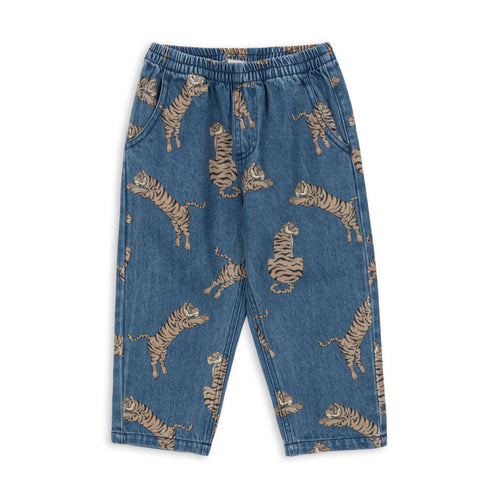 Blue denim pants with tiger print on a white background