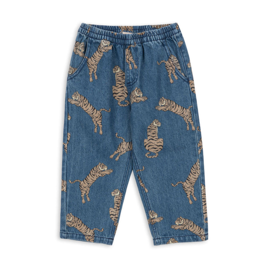 Blue denim pants with tiger print on a white background