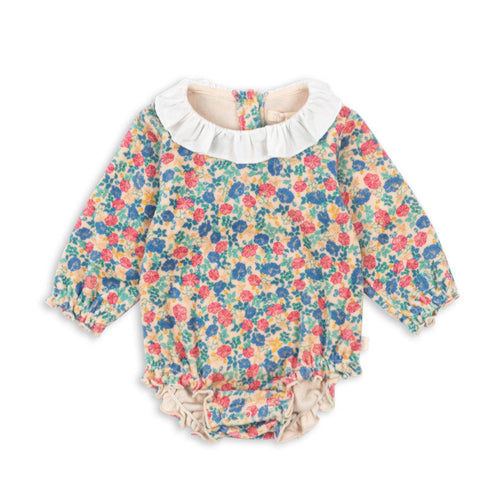 Floral baby romper with ruffled collar on a white background