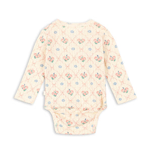 Floral patterned baby onesie on a white background
