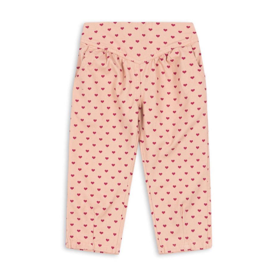 Pink pants with red heart pattern on a white background