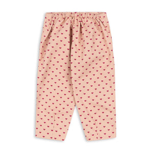 Pink pants with red heart pattern on a white background