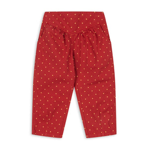 Red pants with white polka dots on a white background