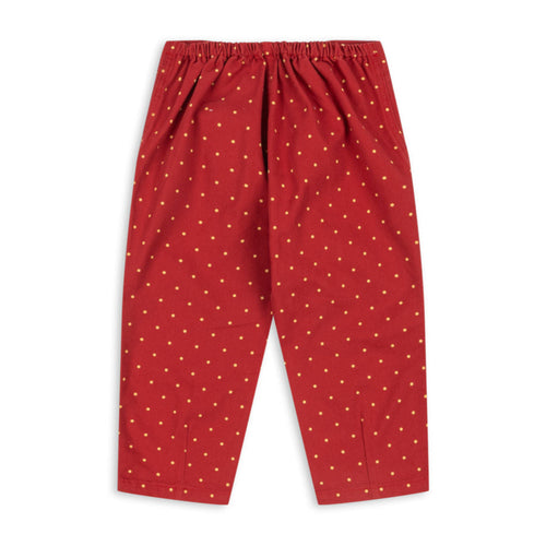 Red pants with white polka dots on a white background