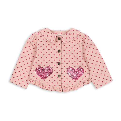 Pink polka dot blouse with heart designs on a white background