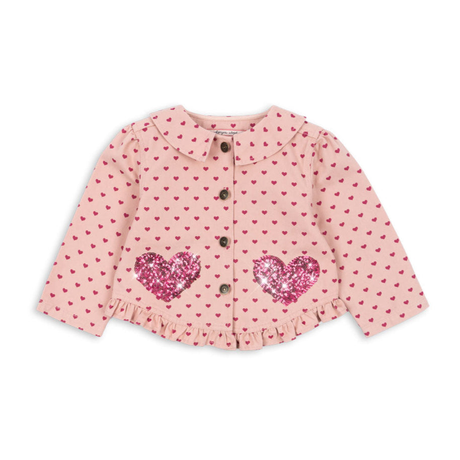 Pink polka dot blouse with heart designs on a white background