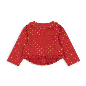 Red polka dot blouse on a white background
