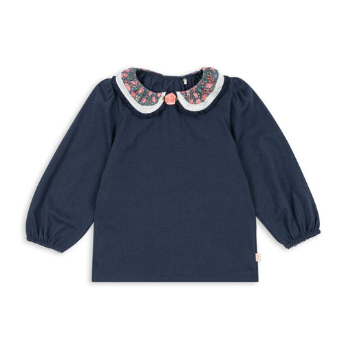 Navy blue blouse with floral collar on a white background