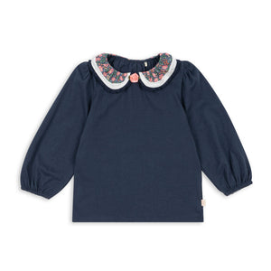 Navy blue blouse with floral collar on a white background