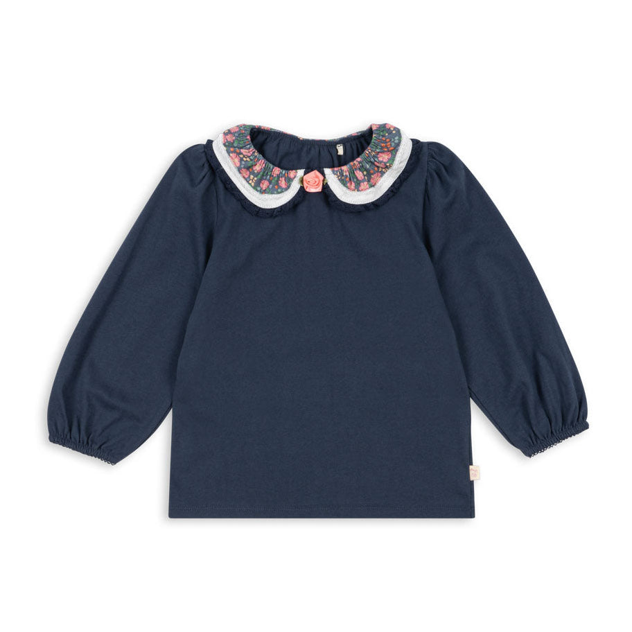 Navy blue blouse with floral collar on a white background