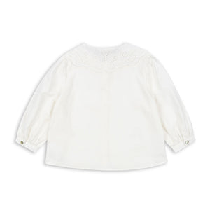 White blouse with long sleeves on a white background