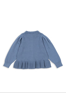 Blue sweater with ruffled hem on a white background