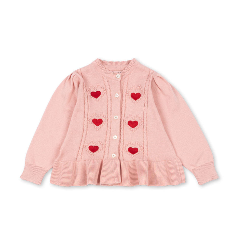 Pink cardigan with heart patterns on a white background